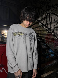 Model wearing the Cyber Sigilism Thermal grey waffle knit long sleeve, relaxed boxy fit, Uso Wanai script and chest print