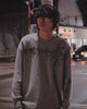 Model wearing the Cyber Sigilism Thermal grey waffle knit long sleeve on a city street at night, showing the relaxed boxy fit