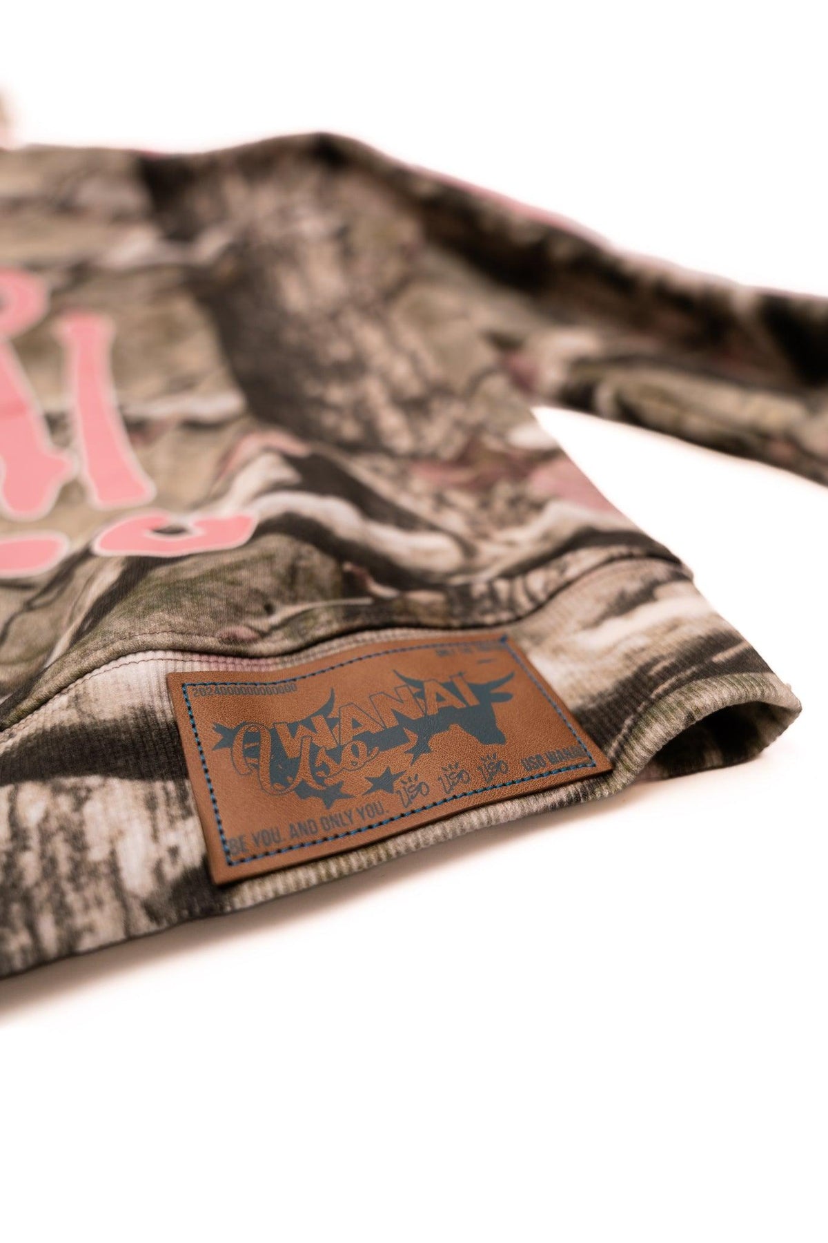 Uso Wanai Real Tree Camo Hoodie faux leather patch detail with embossed logo on 400 GSM French Terry